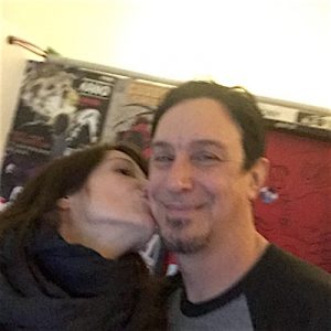 Left: Monica Mel of Global Rockstar (kissing) – Right: Lou Koller (blushing)